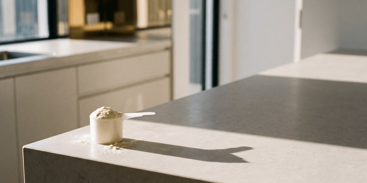 A single scoop of powder on the corner of a kitchen bench with empty space beside it — HLTH+
