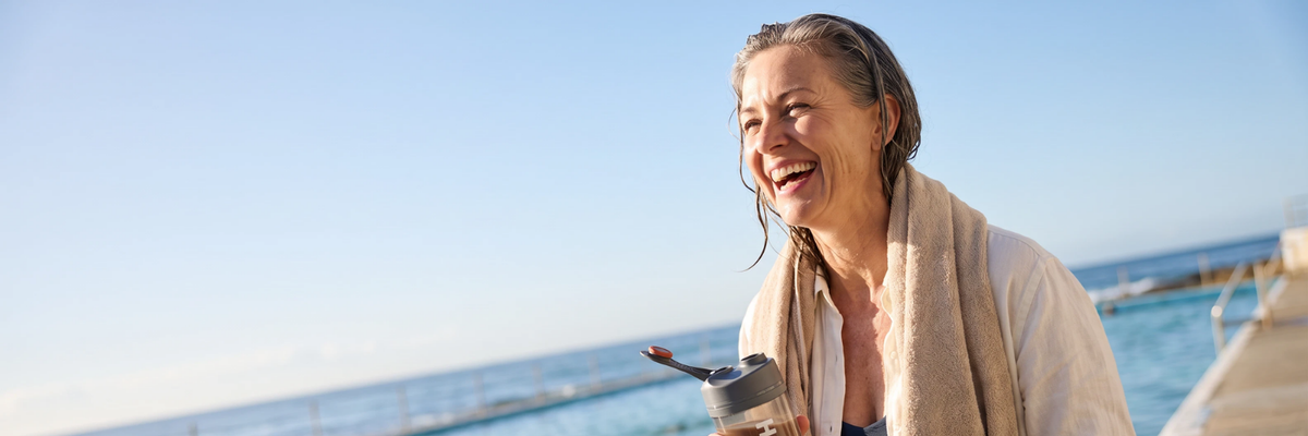 A woman on a walk, HLTH+ shaker in hand